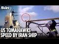 Moment US Tomahawk missiles speed just above cargo ship heading towards Iran