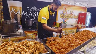 Indian Maestro Roasts Mive Amounts Of Chicken Tikka Masala. Street Food Event In Italy