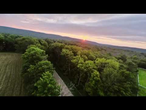 Sunset FPV rip and aerobatics over a field in Connecticut