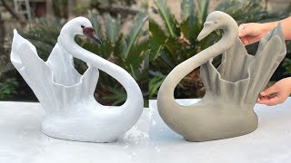 The swan-shaped plant pot design from cement and old fabric is very beautiful eye