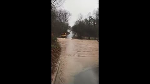 RAW: School bus caught on video driving through floodwaters