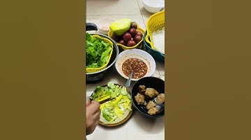 Bún mắm cá cơm, ăn kèm với nem chiên, rau xoài và dưa, tráng miệng mận bắc