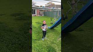 Boy throws black grapple onto monkey bars that doesn't take then pulls it and hits him on face
