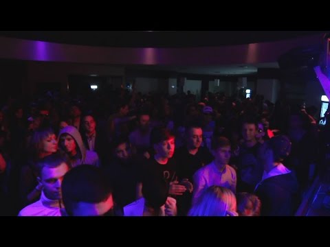 Grooving dancing people at rock concert in nightclub in splashing strobe lights. Stock Footage