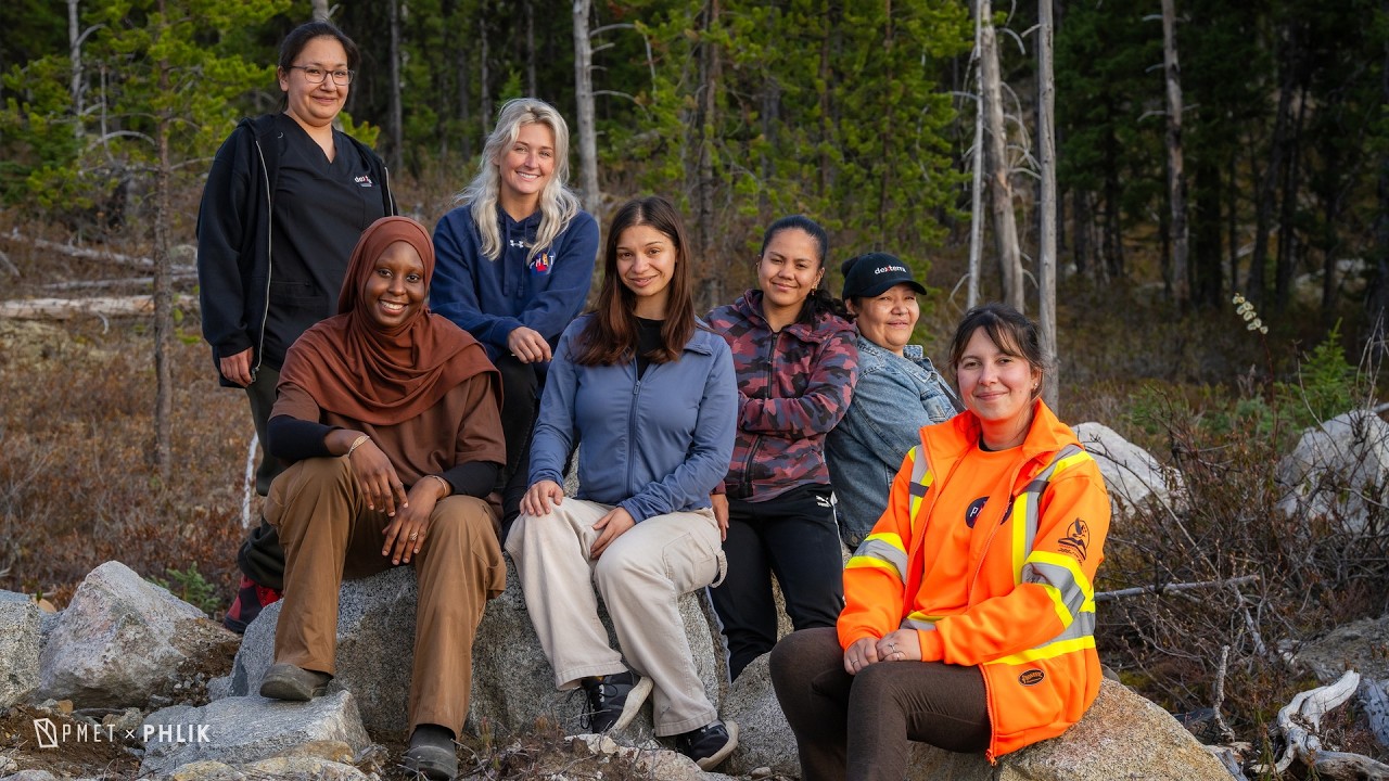 Seven women who work at PMET, seated together on site