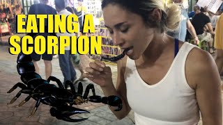 Eating a Scorpion in Bangkok, Thailand