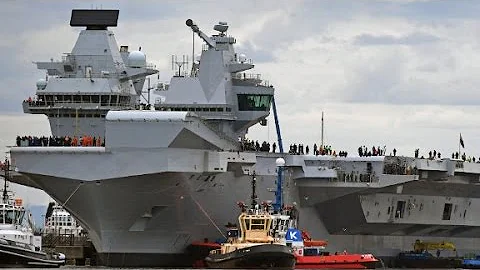 Massive new aircraft carrier navigates away from dock