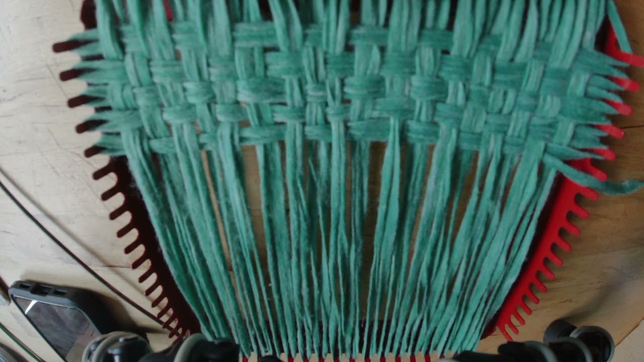 Weaving with loops on the potholder loom.AVI 
