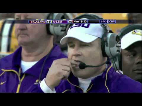 The Mad Hatter and Alice (Les Miles eats grass.)