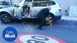 Moment elderly man removes wheel clamp before putting it in boot - Daily Mail