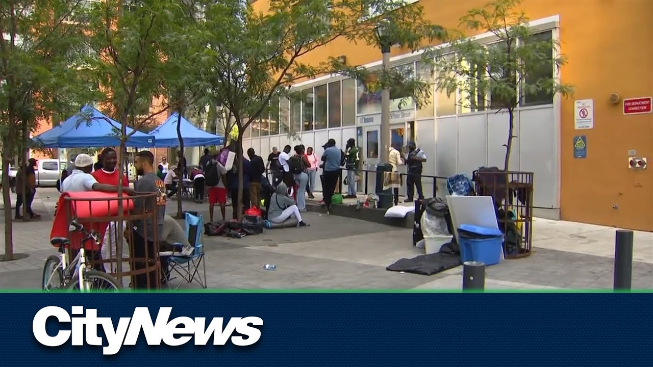 Refugees Square Dozens of refugees return downtown in search of shelter spaces - YouTube