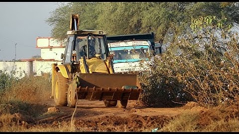 JCB Backhoe Loading Mud and Tata Tipper Unloading Mud For Canal