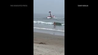People on New Hampshire beach watch as plane crash lands