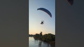 Terrifying moment paraglider hits telephone wires, plummets into river