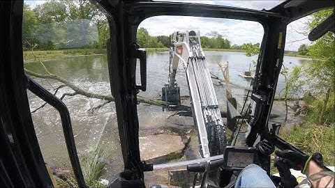 clearing trees from the old farm pond dam with Bobcat e42 R series mini excavator
