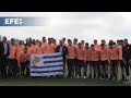 La selección de Uruguay recibe el pabellón nacional de manos del presidente Orsi
