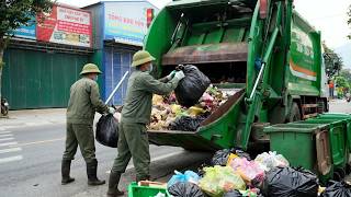 Details Rear-loading garbage truck. Two workers handling the town's heavy waste.ASMR News