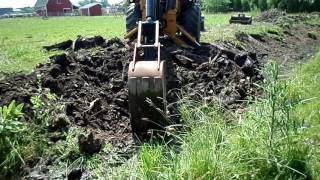 Stump removal with JD310A Backhoe