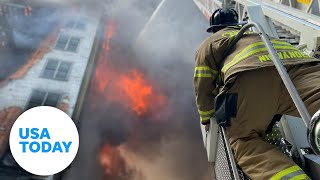 Firefighters battle a large blaze in a building under construction | USA TODAY