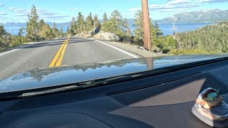 Driving near the west shore of Lake Tahoe listening to music with purple nail polish holding a GoPro