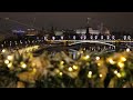 Moscow Kremlin at night reflecting holiday lights on Moskva River cityscape