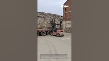 Unloading wood from a truck: people unloading wood from a truck