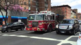 FDNY ENGINE 34 CRUISING BY ON 9TH AVENUE IN THE HELL'S KITCHEN AREA OF MANHATTAN IN NEW YORK CITY.