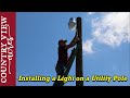 Installing a Light on a Utility Pole.   Lighting up the future equipment parking area.