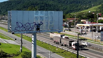 Daytime Graffiti on Billboard with Drone Footage