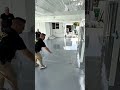 spreading gray epoxy coating on the garage floor and scattering decorative flakes evenly on surface