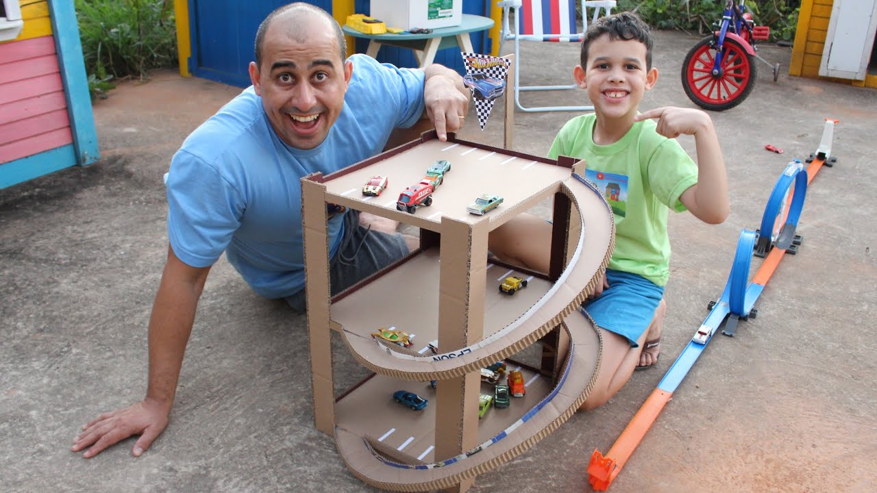 LUCAS E PAPAI BRINCAM COM PISTA HOT WHELLS e com SUPER GARAGEM FEITA DE PAPELÃO