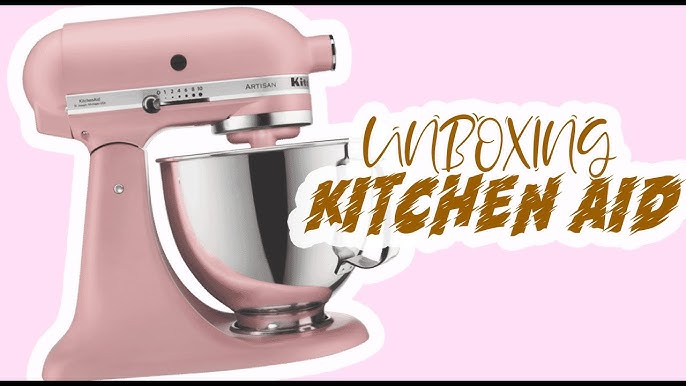 Premium AI Image  A blue kitchenaid mixer with a pink stand mixer on a  wooden table.