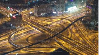 Dubai downtown intersection traffic night with city lights from above timelapse