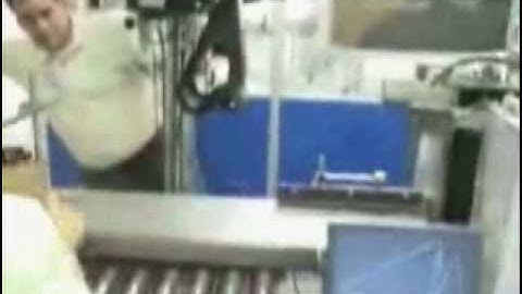 Label Printer Applicator applying labels to the side and top of a box