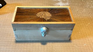 Carpentry, CNC routing, laser cut marquetry, and metal sand casting for a brain surgeon's loupes box