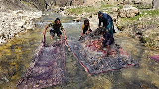 The journey of an old nomadic couple: washing carpets by the river
