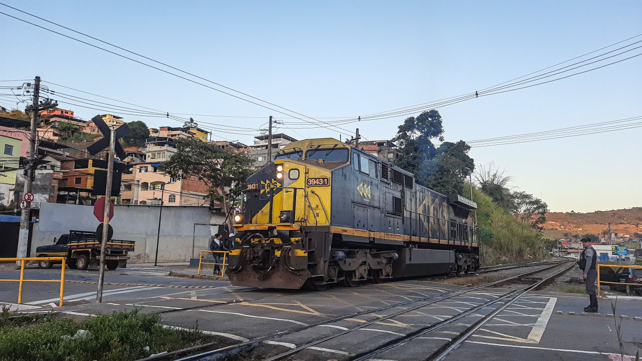Passagem de um trem de carga geral e movimentação da locomotiva C44-EMi no pátio de Santos Dumont-MG