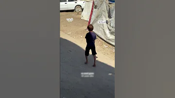 طفل فلسطيني ينتعل علب ا معدنية بدل الحذاء هرب ا من حرارة الشمس الملتهبة 