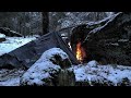 Solo winter camping in snow  deep woods cheap tarpbig rock shelter swedish torch cooking
