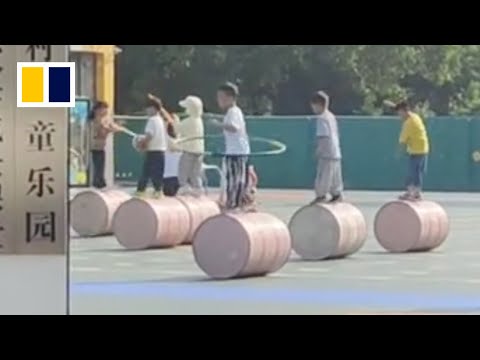 Children practise tricks while walking on cylinder in kindergarten