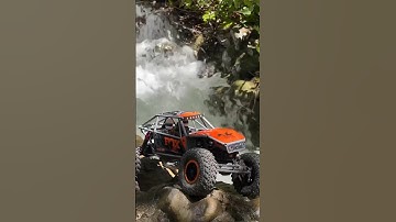 Axial Capra climbing the waterfall 🔥#axial #rccrawler #capra #scx24 #offroad