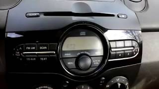 How to set the time on a 2007 to 2014 Mazda 2 car stereo radio deck