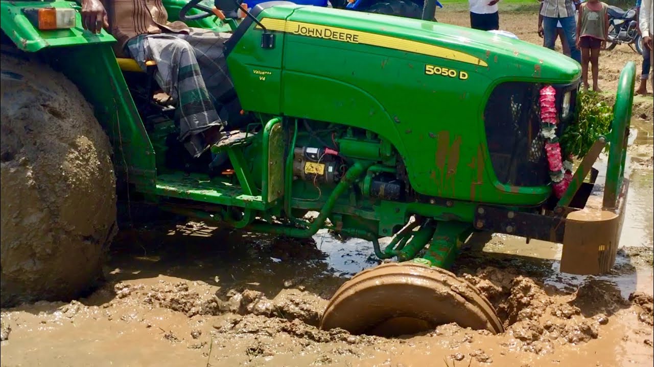 John Deere Tractor Front wheel stuck in mud and Pulling our New ACE