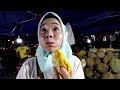 Japanese girl eats "Red Durian" at Local Durian Street in Kota Kinabalu