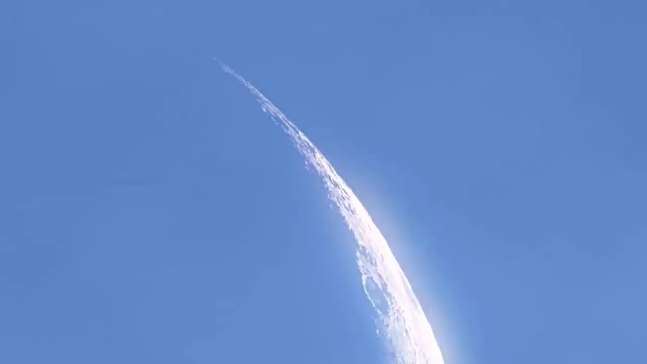 ufo flying over the moon