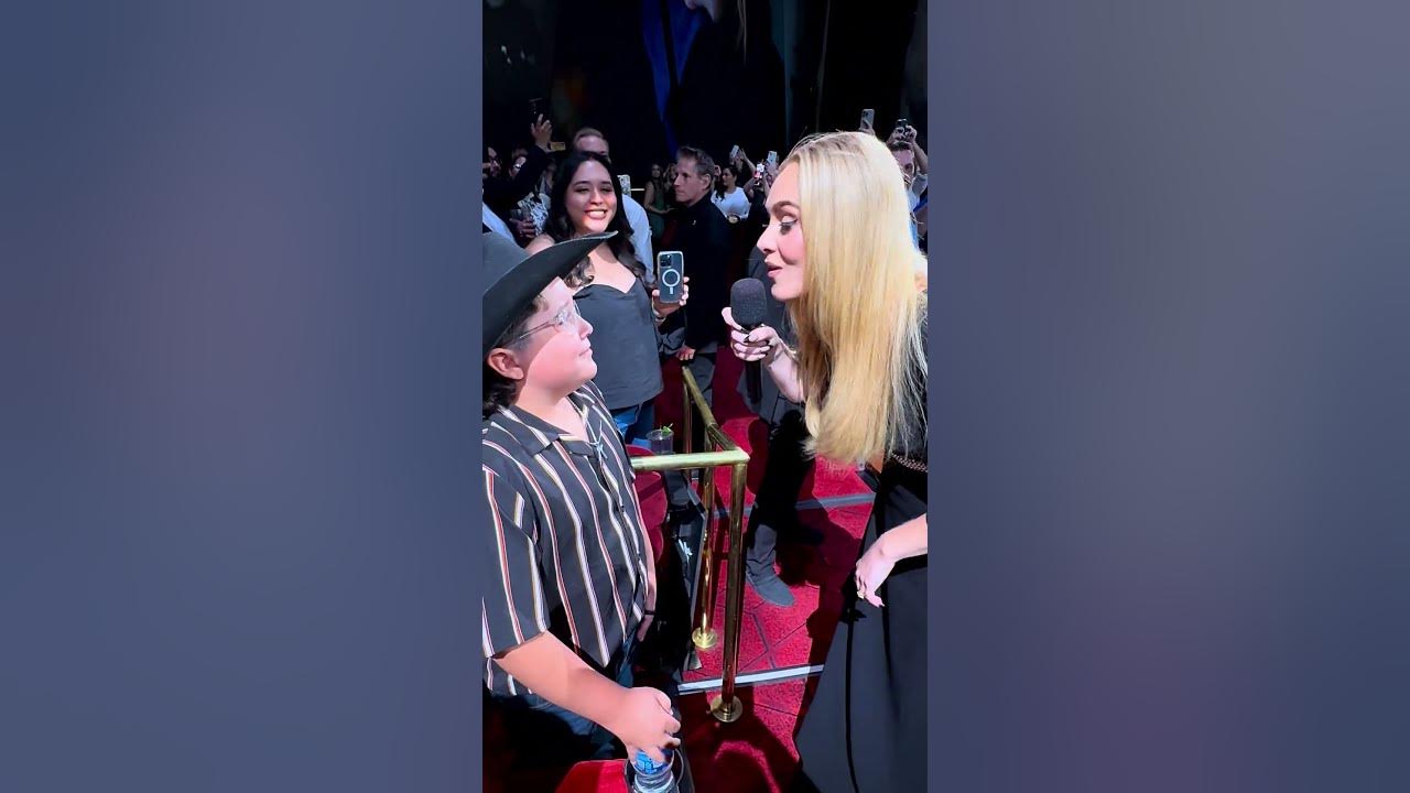 Adele sings to a young fan in the audience