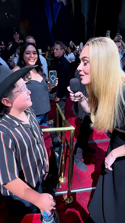 Adele sings to a young fan in the audience