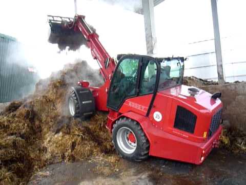 Schaeffer 9330T pivot steer telescopic loader with a bucket and grab