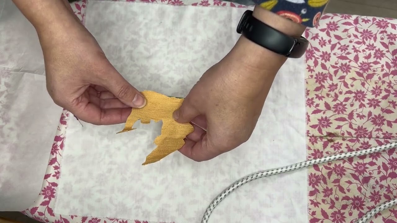 An autumnal scene from fabric using bond-a-web to create a collage.