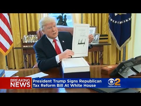 Image result for trump signs tax bill